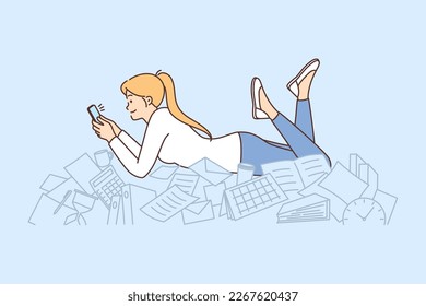 Procrastination woman with phone lies on documents and stationery oblivious to mess. Girl office worker spends working time on procrastination without performing official duties