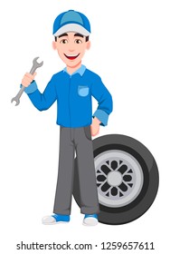 Professional auto mechanic in uniform. Smiling cartoon character stands near wheel and holds wrench. Expert service worker. Vector illustration