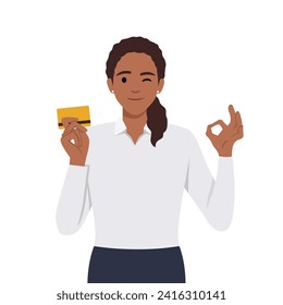 Mujer profesional mostrando o sosteniendo tarjetas de crédito o débito o cajero automático y haciendo gestos con buena o buena señal, mientras le hace el ojo al ojo. Ilustración vectorial plana aislada en fondo blanco