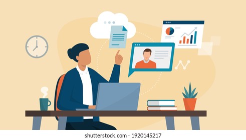 Professional business woman sitting at desk and connecting with her laptop, she is video calling her colleague and sharing files online on the cloud