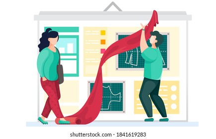 A professional designer explains to seamstress the principles of making clothes. Man holds a piece of textile in his hands. Atelier for tailoring to order. The girl looks at the work of the master
