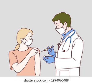 Professional doctor giving COVID-19 vaccine injection to woman at clinic. Woman getting a COVID-19 vaccine, Corona Virus Protection. 