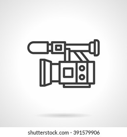 Professional equipment for filming and video. Camera with microphone. Film industry, movie, cinema. Black line style single vector icon. Element for web design, business, mobile app. 