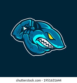 A professional flat vector mascot logo featuring a powerful shark character. The design depicts a muscular blue shark with an aggressive expression, glowing yellow eyes, and sharp teeth flexing its bicep. Set against a dark navy background with a clean white stroke outline, this high impact emblem is ideal for esports teams, gym branding, competitive swimming clubs, and marine themed streetwear.