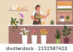 Professional florist working in her flower shop she is preparing a beautiful gift bouquet