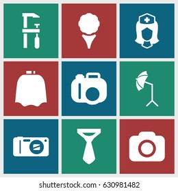 Professional icons set. set of 9 professional filled icons such as hairdresser peignoir, tie, chainsaw, nurse, camera, studio umbrella