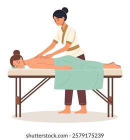 A professional massage therapist provides a relaxing back massage to a client lying on a massage table, covered with a green towel