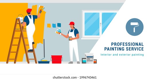 Professional painters and decorators painting walls in a residential room with professional equipment