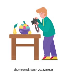 Professional photographer cartoon character making photo shoot of still life, flat vector illustration isolated on white background. Man photographing fruits on table.