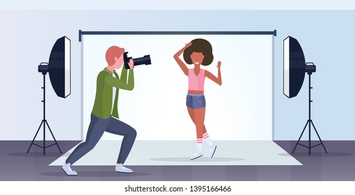 professional photographer using camera man shooting beautiful sexy african american woman model posing modern photo studio interior horizontal full length