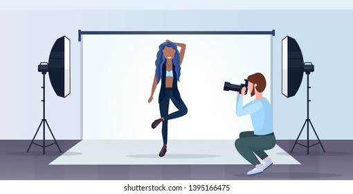 professional photographer using camera man shooting beautiful sexy african american woman model posing modern photo studio interior horizontal full length