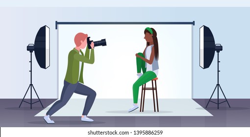 professional photographer using camera man shooting beautiful sexy african american woman model posing modern photo studio interior horizontal full length