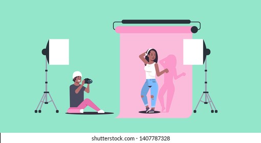 professional photographer using camera man shooting beautiful sexy african american woman model posing modern photo studio horizontal full length flat