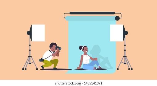 professional photographer using camera man shooting beautiful sexy african american woman model posing modern photo studio horizontal full length flat