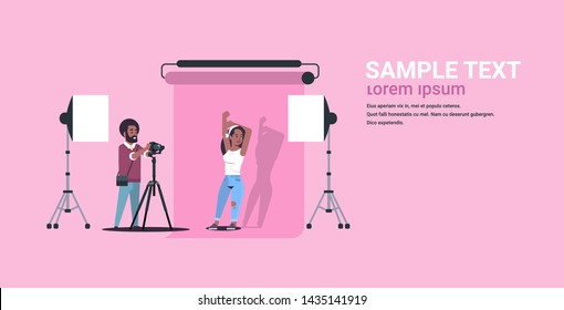 professional photographer using camera man shooting beautiful sexy african american woman model posing modern photo studio horizontal full length flat copy space