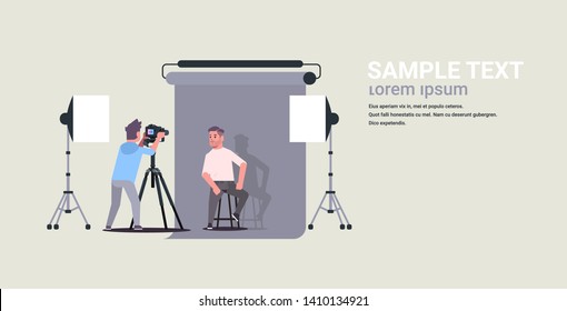 professional photographer using camera shooting business man model posing in modern photo studio interior horizontal full length flat copy space