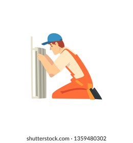 Professional Plumber Installing Radiator, Male Construction Worker Character in Orange Overalls and Blue Cap Vector Illustration