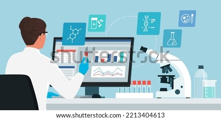 Professional scientist woman working in the medical laboratory, she is checking test results on the computer and holding a vial, microscope and medical equipment on the desk, medical research concept