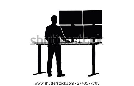 Professional it specialist working at standing desk with multi monitor setup in control room.