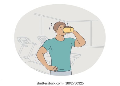 Professional sport, workout, training concept. Young man athlete standing and drinking water after training in gym and feeling energetic. Active lifestyle, fitness, bodycare, wellness