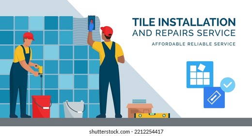 Professional tilers installing tiles on a wall using professional tools, home renovation concept