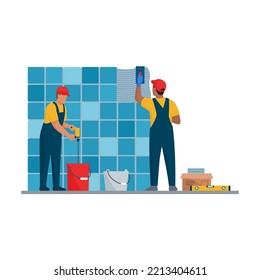 Professional tilers installing tiles on a wall using professional tools, home renovation concept