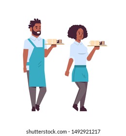 professional waiters couple holding coffee and cake on tray african american man woman restaurant workers in apron serving food concept flat full length white background