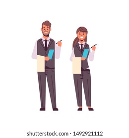 professional waiters couple making notes man woman restaurant workers in uniform holding notepad and towel taking order concept flat full length white background