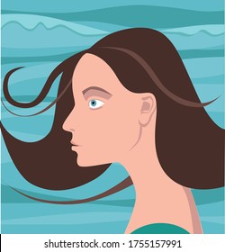 Profile of a beautiful woman whose hair is developing in the wind against the background of sea waves