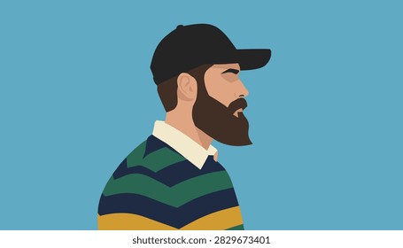 Profile portrait of a handsome bearded man wearing a black baseball cap and striped sweater against blue background.