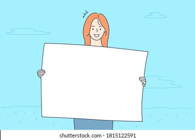 Promotion, business, advertising, protest concept. Young happy smiling businesswoman clerk manager girl cartoon character protestor holding banner in hands looking at camera. Corporate promo ads.