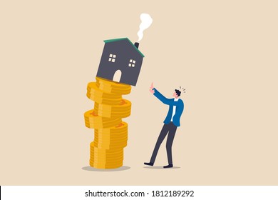 Property And Housing Market Collapse, Real Estate Stock Risk Or Economic Recession Concept, Businessman House Owner Or Real Estate Agent Help Protect The House To Fall Off Unstable Stack Of Coins.