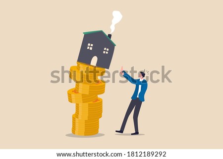 Property and housing market collapse, real estate stock risk or economic recession concept, businessman house owner or real estate agent help protect the house to fall off unstable stack of coins.