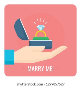 Proposal ring in hand with text marry me