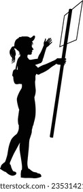 Protestor or demonstrator at a demonstration march, picket line or strike protest rally in silhouette. Holding up a banner or picket sign board placard.