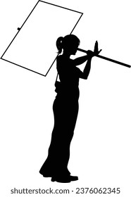 Protestor or demonstrator at a demonstration march, picket line or strike protest rally in silhouette. Holding up a banner or picket sign board placard.