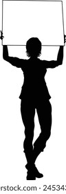 Protestor or demonstrator at a demonstration march, picket line or strike protest rally in silhouette. Holding up a banner or picket sign board placard.