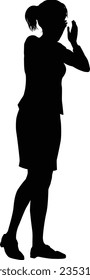 Protestor or demonstrator shouting at a demonstration march, picket line or strike protest rally in silhouette. 
