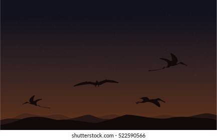 pterodactyl on sky landscape of silhouettes