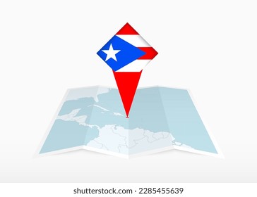 Puerto Rico is depicted on a folded paper map and pinned location marker with flag of Puerto Rico. Folded vector map.
