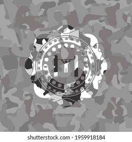 pull up icon inside grey camouflaged emblem. 