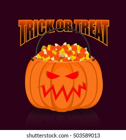 Pumpkin basket for Halloween. Trick or treat. Corn candy for terrible holiday. Horrible vegetable basket of sweets
