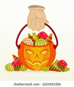 Pumpkin buckets filled with candy and chocolate for Halloween celebrations. halloween background.