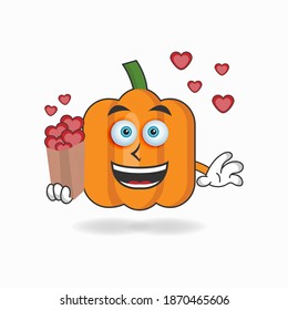 Pumpkin mascot character holding a love icon. vector illustration