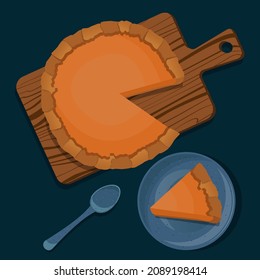 Pumpkin pie on wooden cutting board, piece of pie in blue ceramic plate with spoon isolated on dark emerald background.
