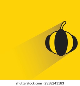 pumpkin with shadow on yellow background