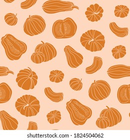 Pumpkin stylish seamless pattern. Autumn orange food fabric design in hand-drawn style. Whole and slices of pumpkin isolated on pastel orange background. 