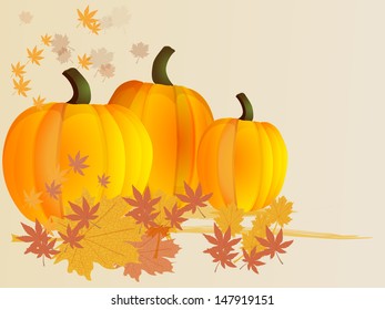 Pumpkins among autumn leaves