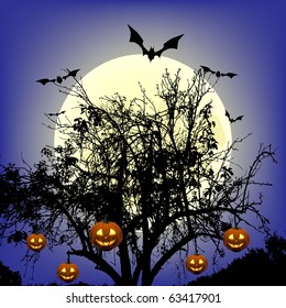 Pumpkins hanging on the tree at moonlight