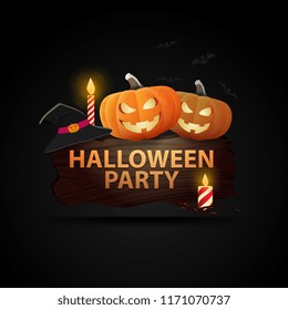 Pumpkins and a witch hat on a piece of wood with the inscription: "Helloween party"